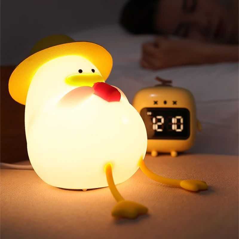 Duck shaped silicone night lamp illuminating a bedroom for cozy ambiance.   