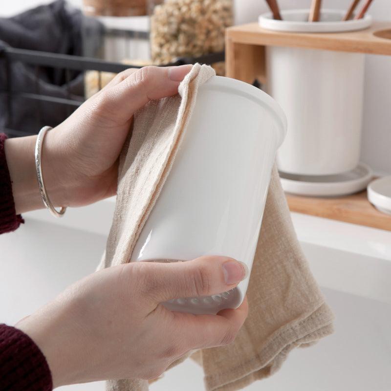 Nordic household ceramic chopstick holder being cleaned with a cloth.