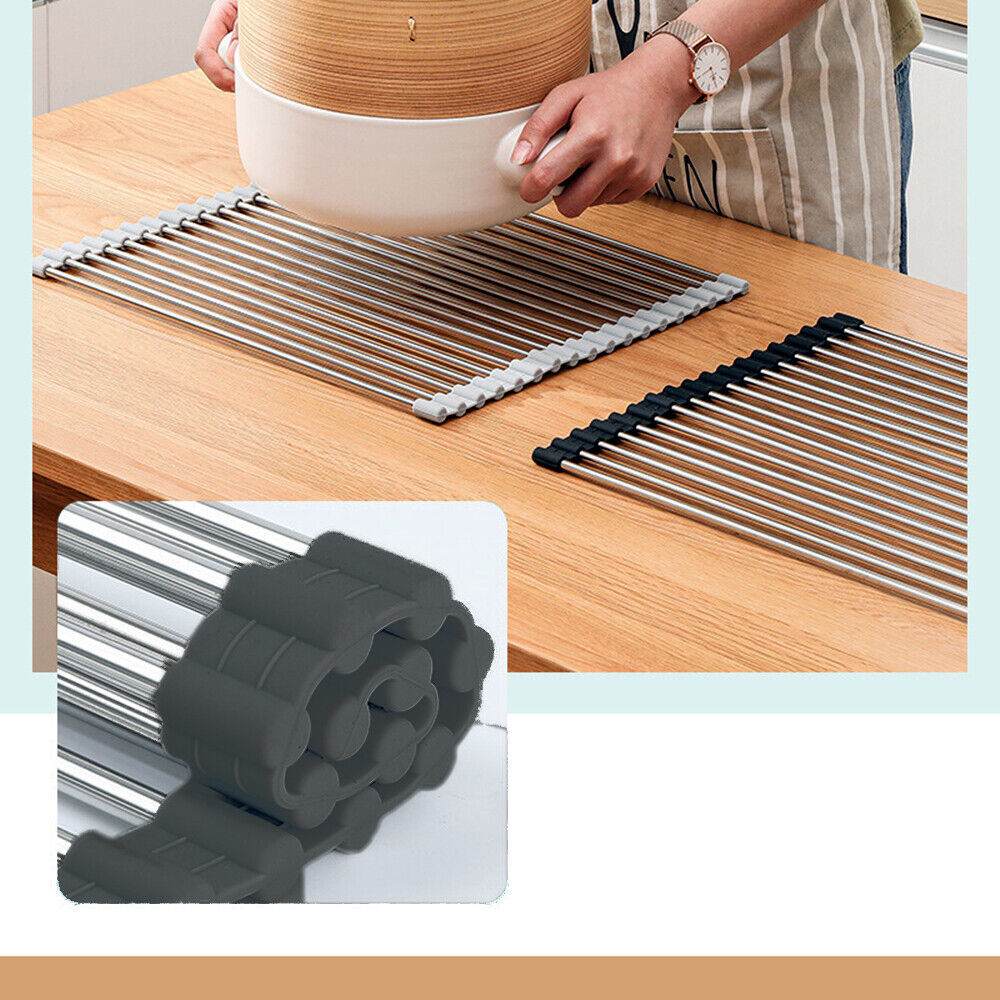 Kitchen stainless steel sink drain rack roll-up dish drying mat with silicone edges, used for drying dishes and as a cutting board; shown in use.