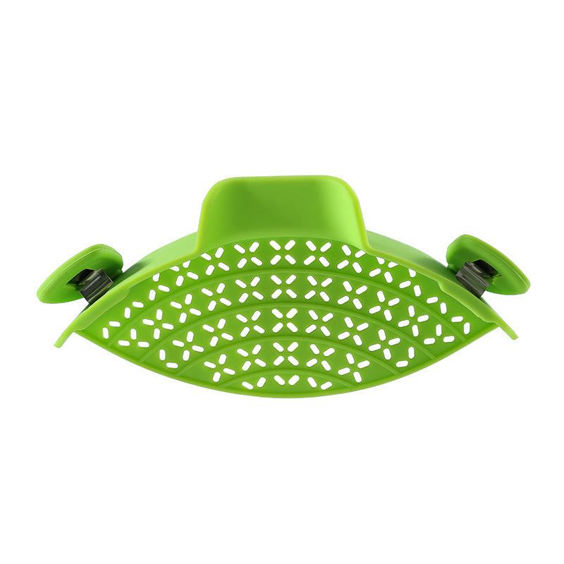 Green silicone pot side drain stopper, modern minimalist kitchen gadget.