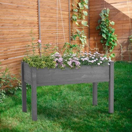 Elevated wooden garden bed with legs, grey solid wood planter for outdoor plants.