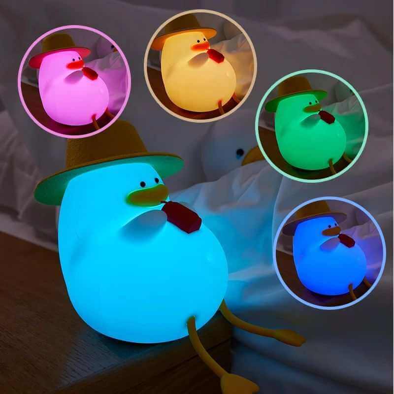Colorful silicone duck night lamp with hat, features multiple LED light settings.   