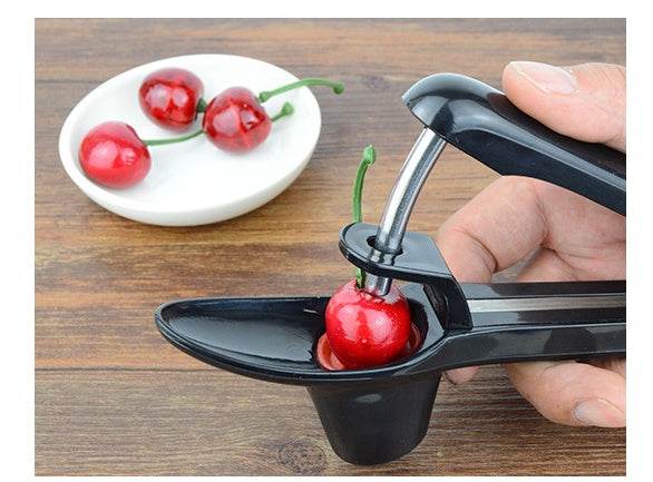 Cherry Red Date Cherry Kernel Remover with black ABS material, shown removing pit from cherry.