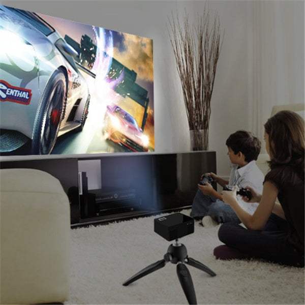 USB smart projector displaying a racing game in a living room setting.