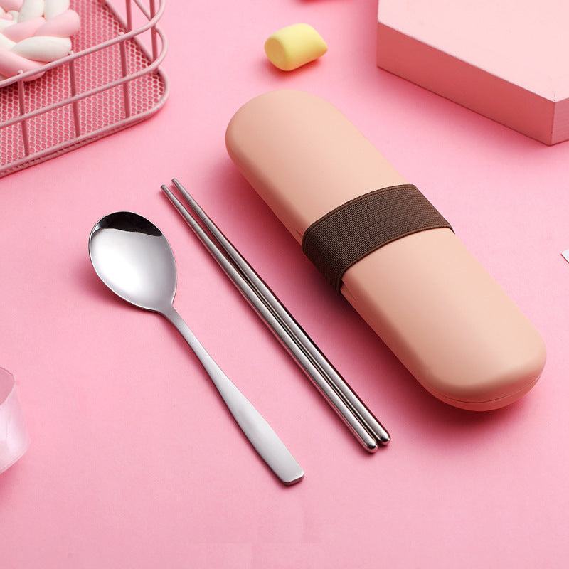 Stainless steel portable cutlery set with chopsticks, spoon, and pink case on pink background.