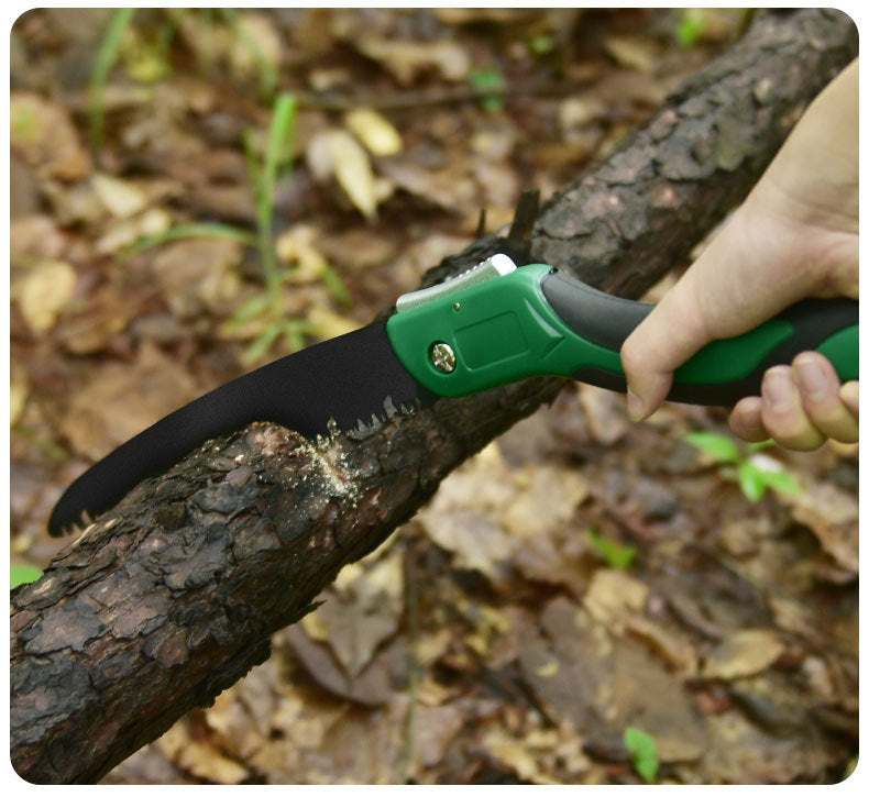 Folding hand saw in use for woodworking outdoors.