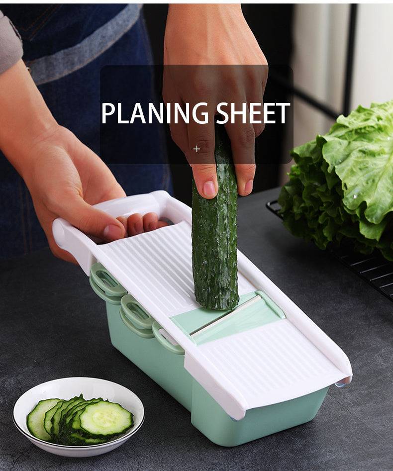 Eco-friendly multifunctional kitchen utensil, mandoline slicer in green and white, ideal for slicing vegetables.