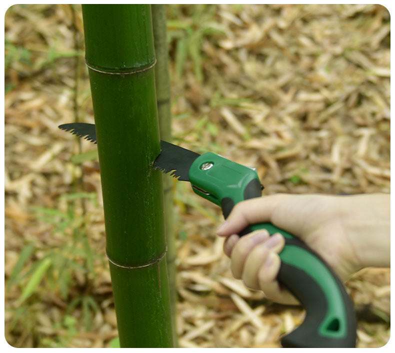 Folding hand saw cutting bamboo, ideal for woodworking and outdoor use.