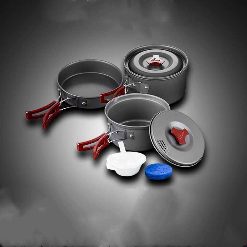 Camping cookware set with pots and frying pan, made of hard alumina, featuring red handles and a compact design.