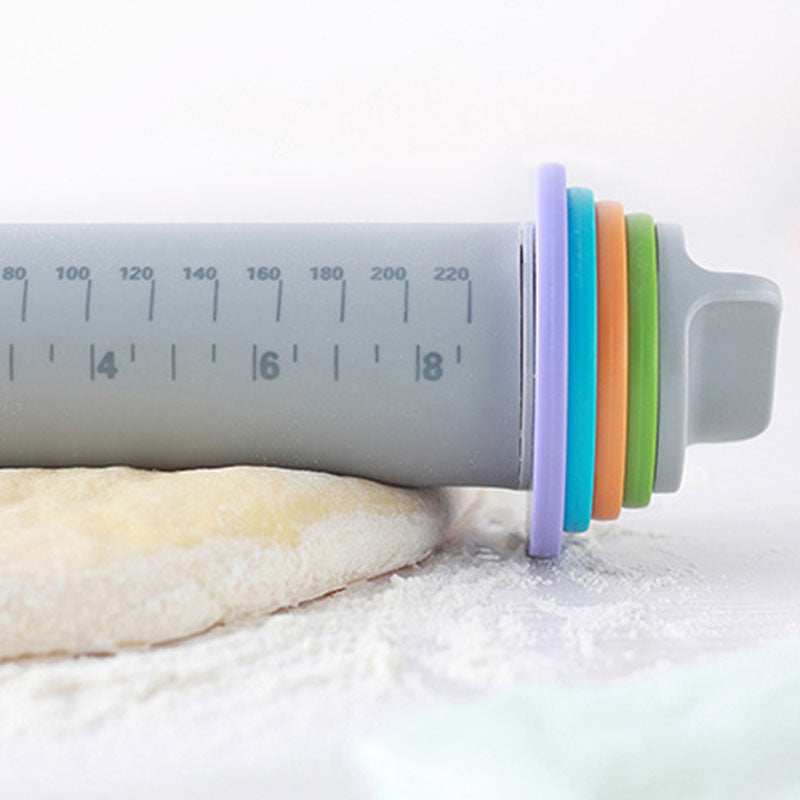 Adjustable thickness rolling pin with colorful rings for precise dough measurement.