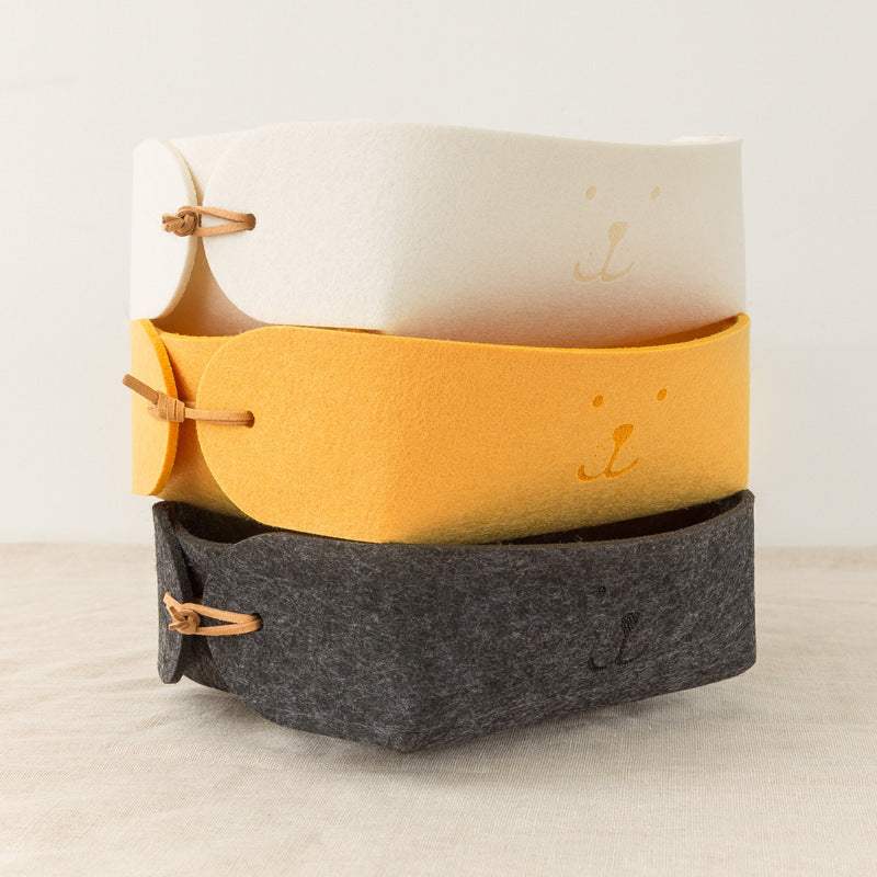 Mini wool felt storage baskets in yellow, beige, and dark gray with a smiley design, ideal for organizing jewelry and sundries.