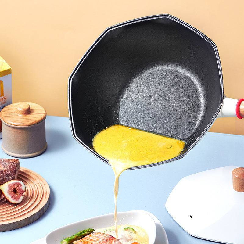 Non-stick frying pan with egg being poured, featuring double pour spouts, anti-scald handle, aluminum material, and multi-layer bottom.