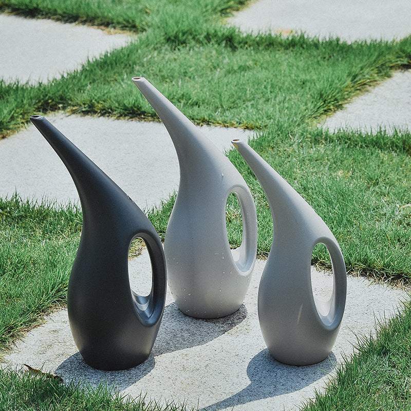 Gardening household watering cans in dark gray and light gray, stylish design for indoor and outdoor potted plants.