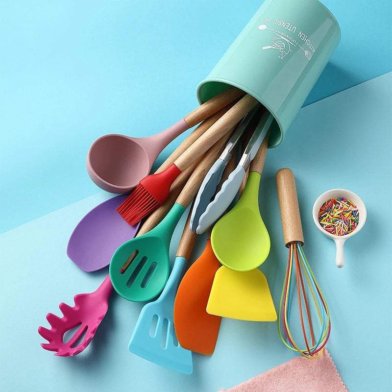 Colorful silicone kitchenware set with wooden handles in a green container.
