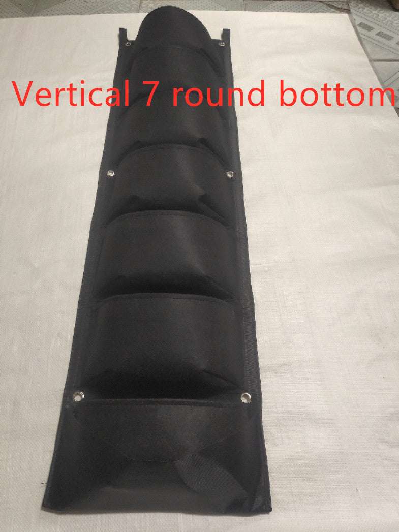 Wall garden hanging planting bag with 7 vertical pockets for indoor and outdoor herb and flower gardens.