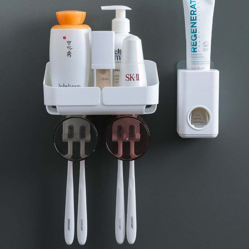 Plastic toothbrush holder with suction cup, featuring space for multiple toothbrushes and a toothpaste squeezer.