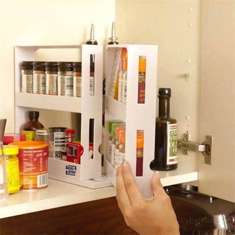 Double rotating kitchen spice organizer rack installed in a cabinet, holding various spice bottles.