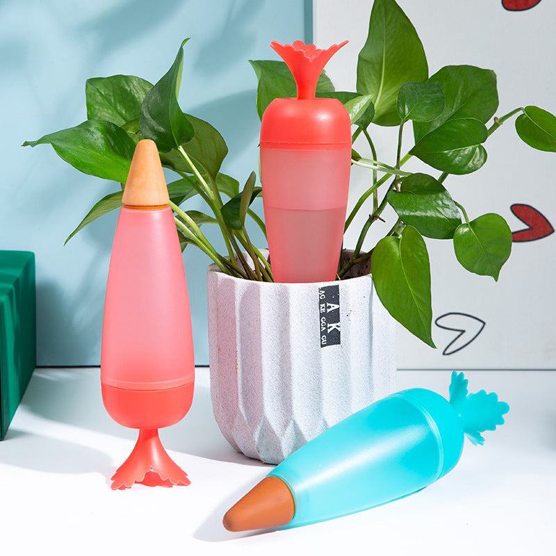 Plastic self-watering globes with colorful tops for indoor plants.