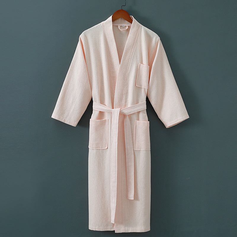 Five star hotel bathrobe in soft cotton and mink hair fabric, winter suitable, hanging on a dark background.