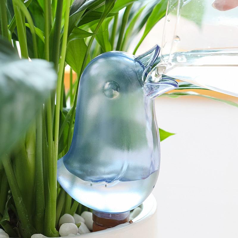 Cute bird-shaped potted plant waterer spike in use, providing water to houseplants.