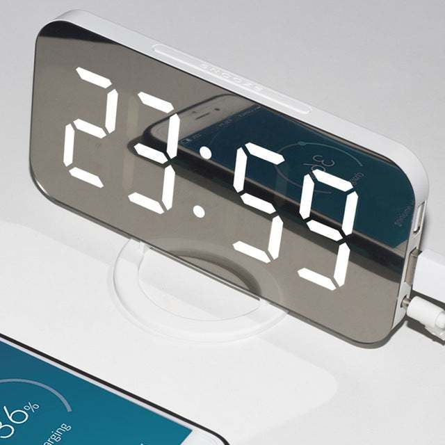 LED alarm clock with dual USB outputs, mirror display, and phone charging feature.