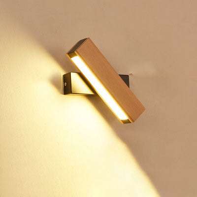 Wooden LED wall lamp with warm light on beige wall, modern adjustable design.