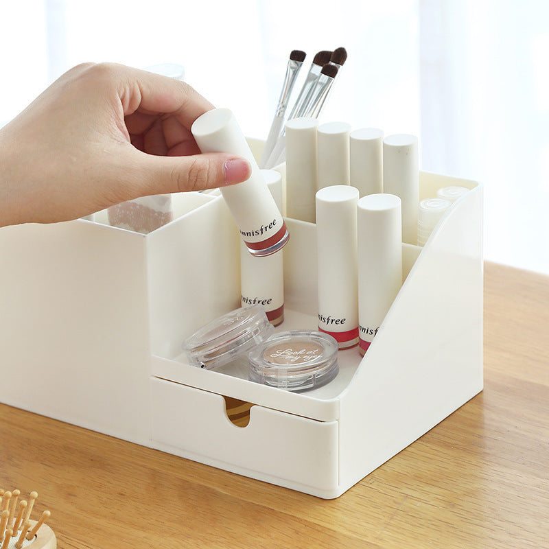 White plastic office desktop storage box organizing various items.