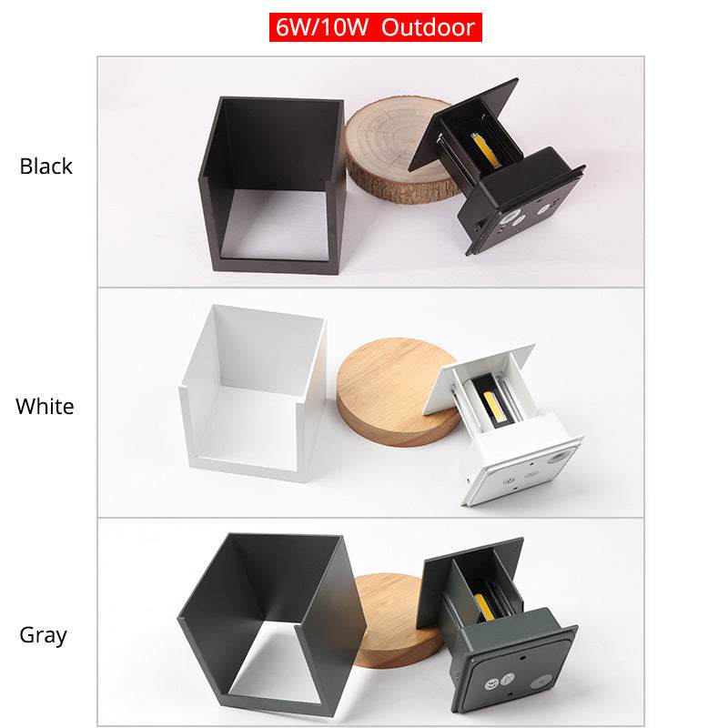 Indoor corridor wall lamp in black, white, and gray colors displayed alongside wooden accents.