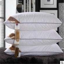 Luxury five-star hotel pillows with polyester fiber filling, rectangular shape, multiple stacked.