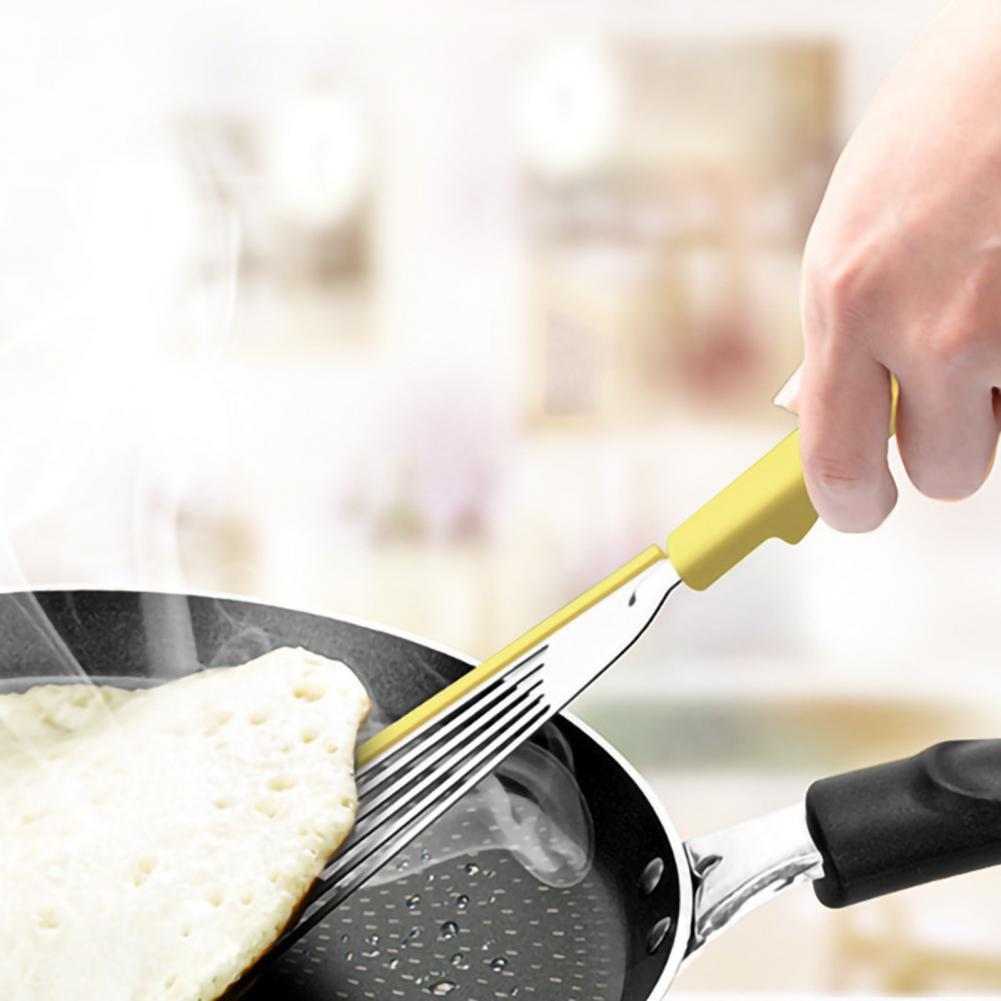Nonstick fish spatula flipping pancake in nonstick pan, ideal for high-heat cooking.