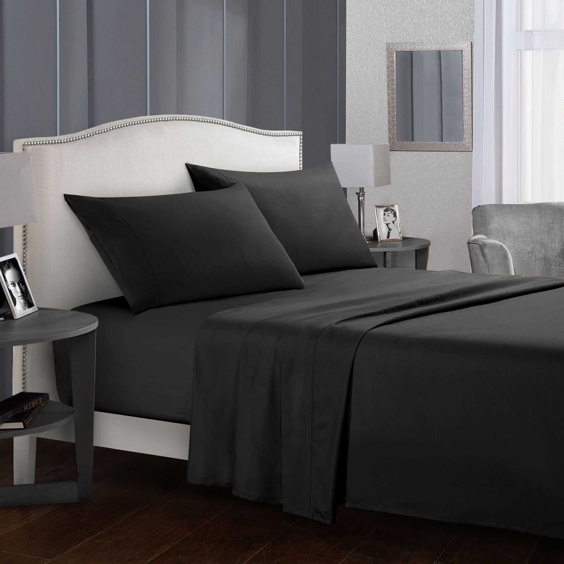 Luxurious four-piece bed sheet set in a modern bedroom setup.