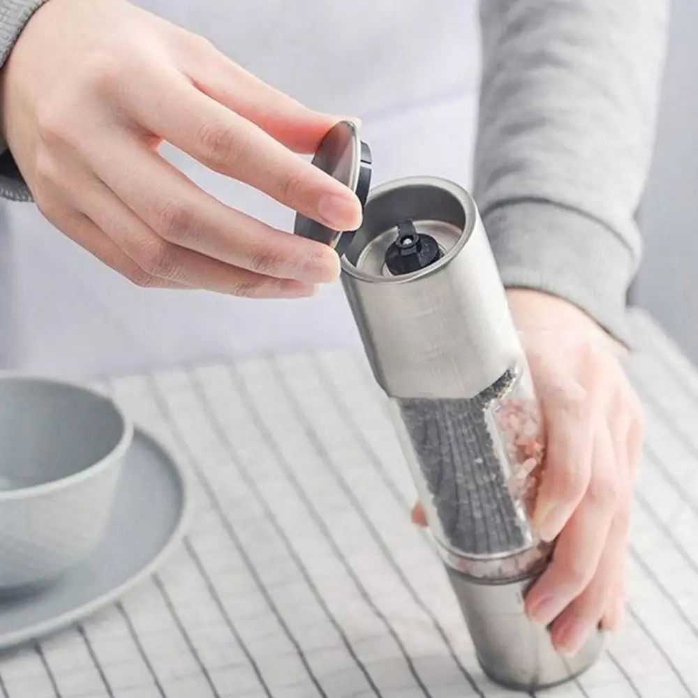 Manual salt and pepper grinder with stainless steel body and adjustable ceramic mill.