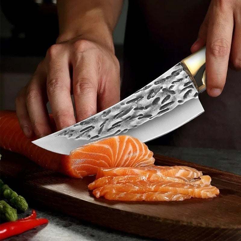 Stainless steel slicing knife cutting salmon on wooden board.