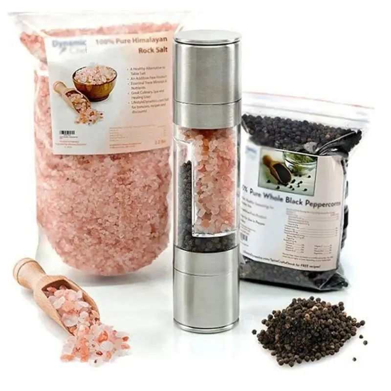 2-in-1 manual stainless steel salt and pepper grinder with adjustable ceramic grinding mechanism, surrounded by pink Himalayan salt and black peppercorns.