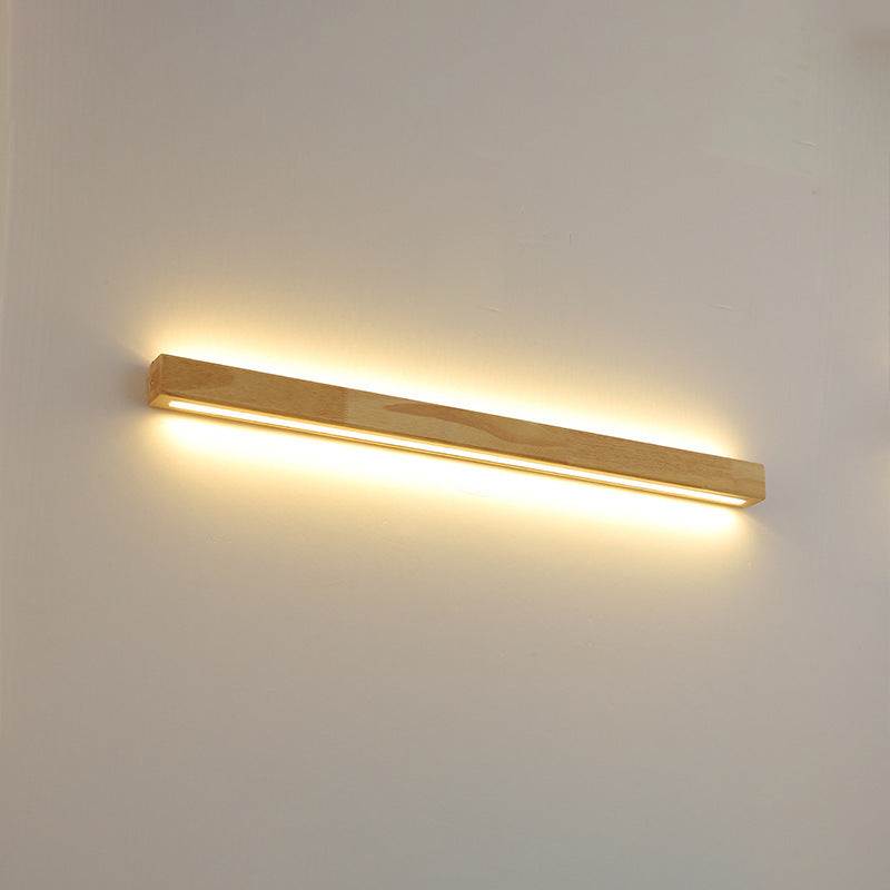 Bedroom bedside background wall lamp with warm light in a Nordic style.