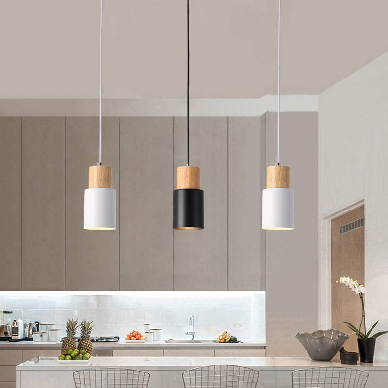 Modern Macaron bedside chandelier in a kitchen setting with adjustable height, featuring iron material and a sleek design.