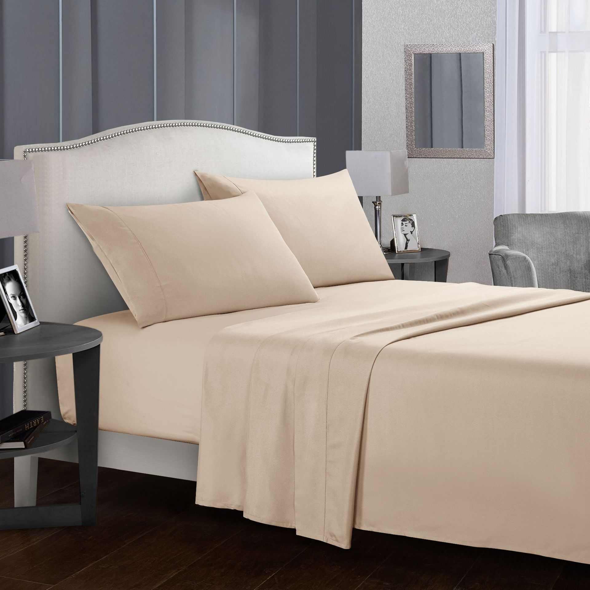 Four-piece bed sheet set in neutral bedroom setting.