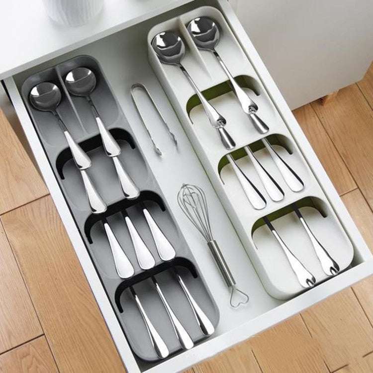 Kitchen drawer cutlery compartment storage box for organized utensils in white and gray.