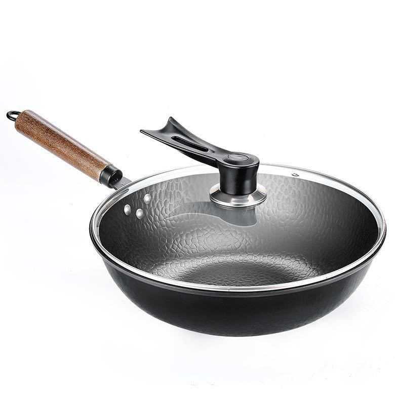 Traditional handmade iron pan with wooden handle and glass lid, made of high-purity refined iron for even heat distribution.