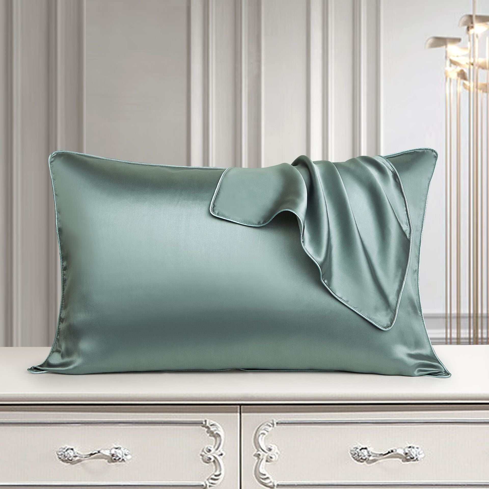 Luxurious mulberry silk pillowcase in light green on elegant dresser.