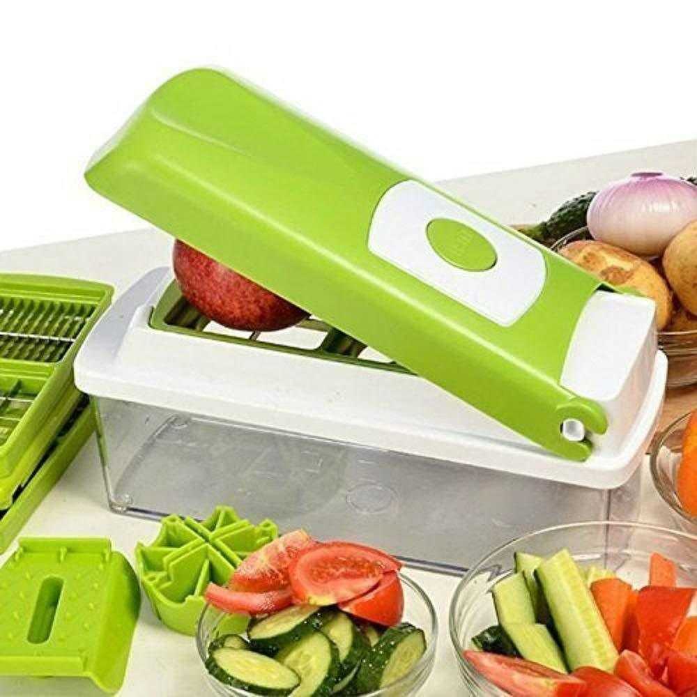 Multifunctional vegetable chopper with green handle slicing fresh produce in kitchen setting. 