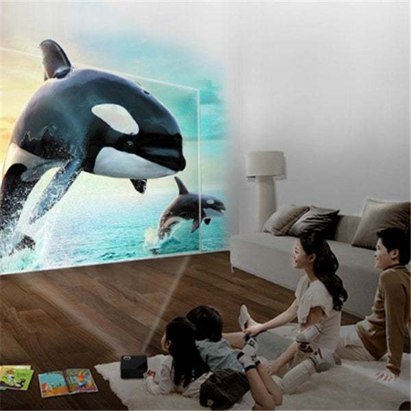 Family watching a movie with projector USB orthographic smart projector displaying vibrant sea life.