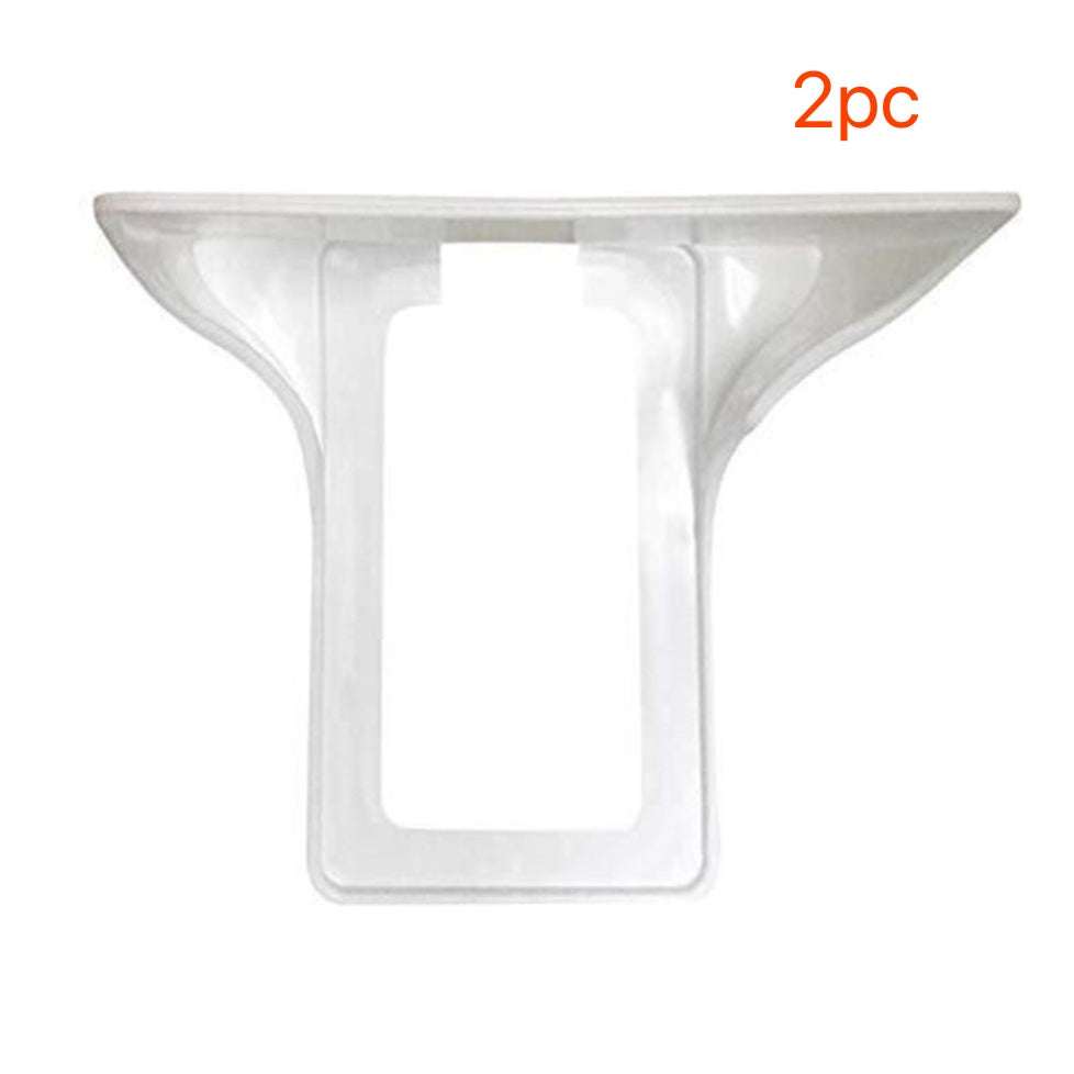 White wall outlet organizer for phone charging and cable management.