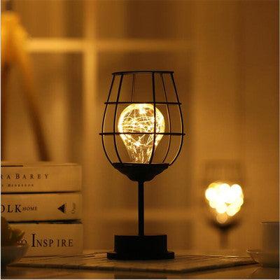 Minimalist iron table lamp with warm white LED light, creative design suitable for home decor.
