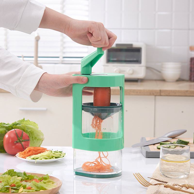 Multifunctional vegetable cutter in use on kitchen counter with fresh vegetables.