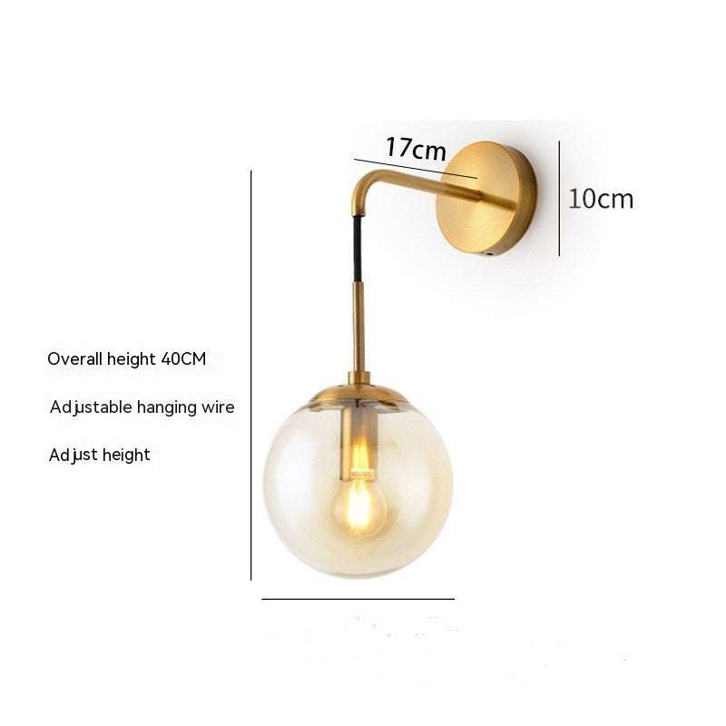 Nordic glass wall lamp with golden finish, adjustable hanging wire, and spherical design.