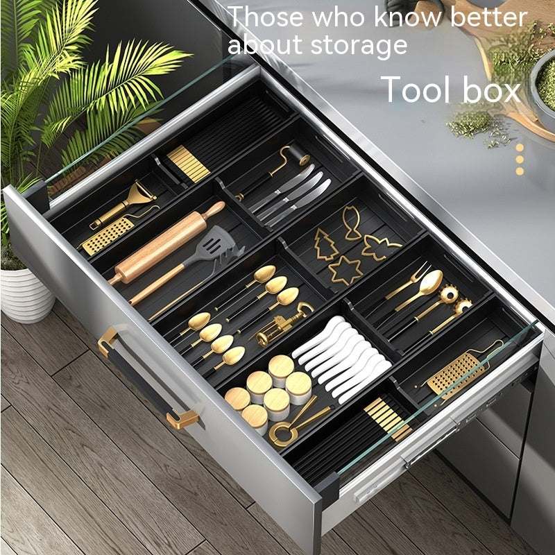 Kitchen drawer storage box partition with organized silverware and utensils in modern design.