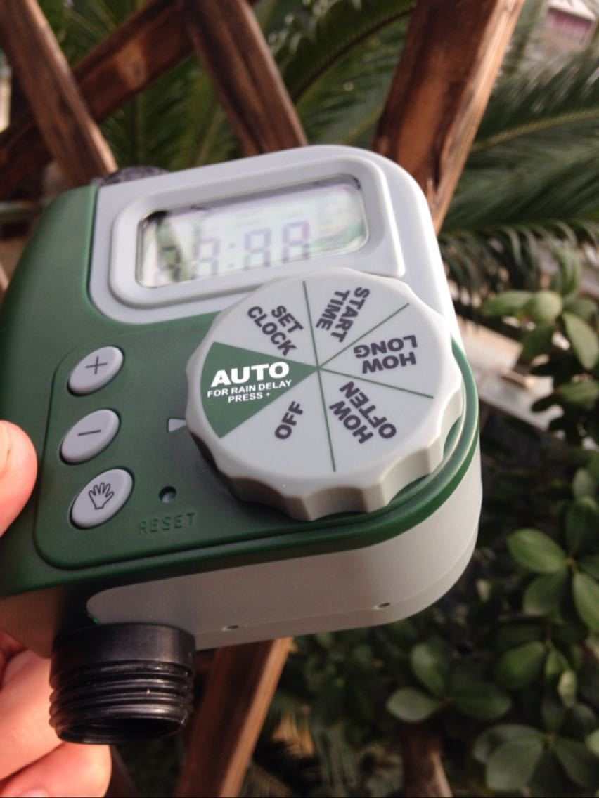 Garden irrigation controller with LCD display and dial settings for automated watering.