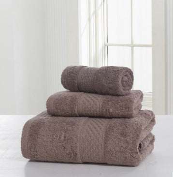 Cotton soft double-sided thickening towel set displayed on table.