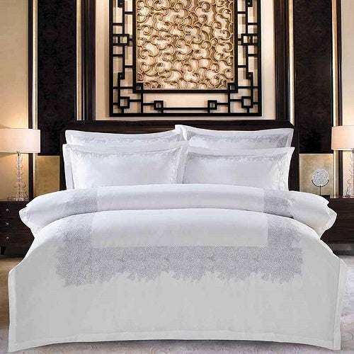 Four-piece cotton bedding set with plain design and twill weave.